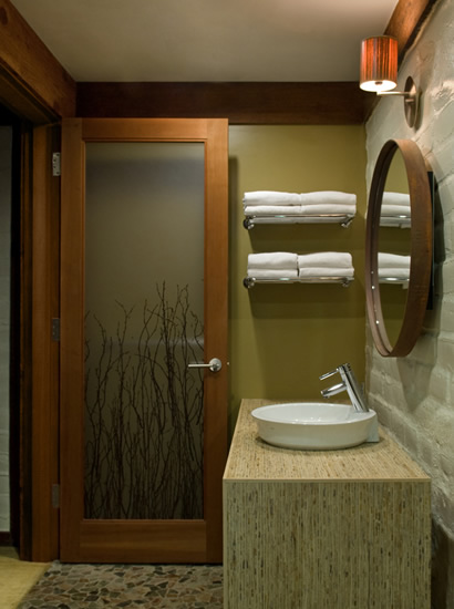 Another view of the bathroom in the Fireside Lodge - Queen cabin, featuring sink, mirror, light fixture and open door.