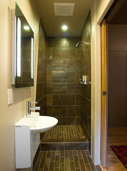 Modern, compact bathroom with heated floors and walk-in showers.