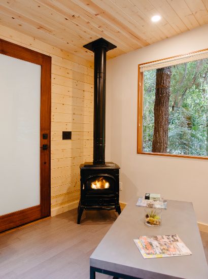 Gas fireplace situated between door and window in living area.
