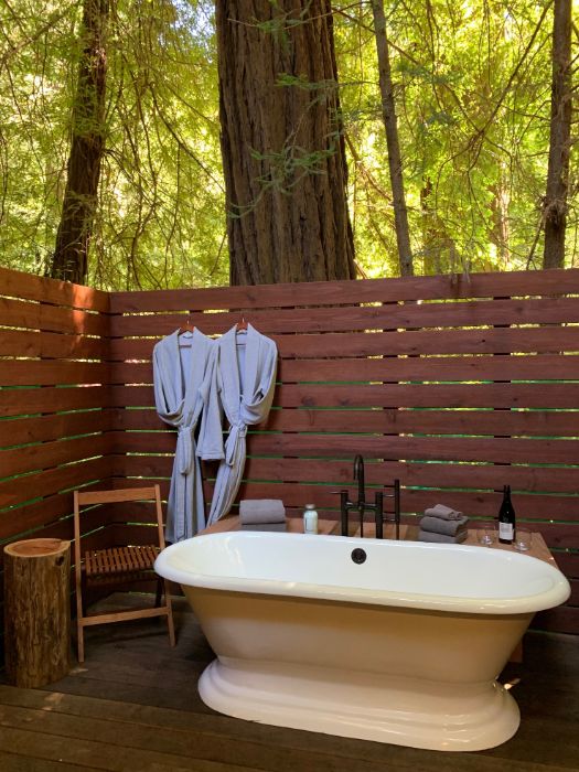 Private patio and outdoor soaking tub set amongst soaring California coastal redwoods.  