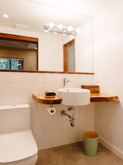Bathroom with large mirror and heated tile floors.
